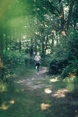 Fitness woman running in the morning park