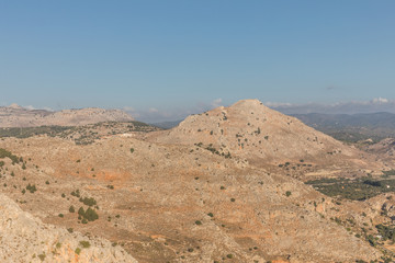 Stony landscape with trees of the Tsambika mountain on the Rhodes Island, Greece