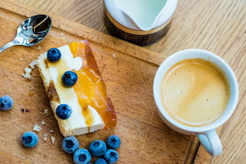 Delicious and sweet cake with blueberries. Sunny dessert on the kitchen table.