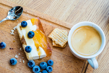 Delicious and sweet cake with blueberries. Sunny dessert on the kitchen table.