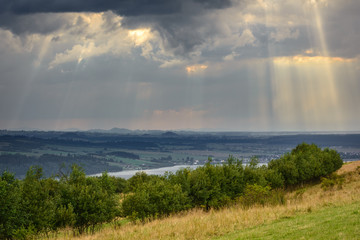 Rays of light pass through the clouds, mountain landscape. Pieniny, Poland.