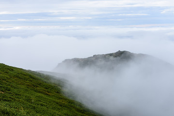 mountain tops in  autumn covered in mist or clouds