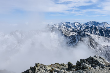 mountain tops in  autumn covered in mist or clouds