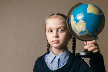 Fototapeta premium Concept - education. Caucasian girl holding a globe