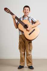 Naklejka premium Boy portrait with acoustic guitar