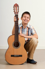 Boy portrait with acoustic guitar