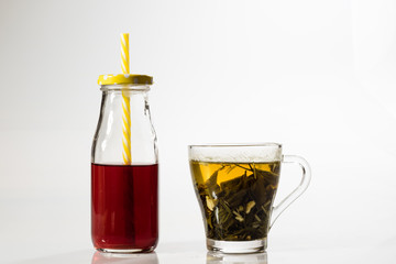 Tea in a glass on a white background. Green or fruit tea.