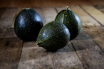 Mini pumpkin on a wooden table, black background