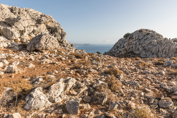 Stony landscape with trees of the Tsambika mountain on the Rhodes Island, Greece