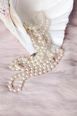 elegant pearl necklace on pink fur in a seashell