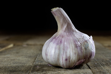 Tasty Italian garlic in an old kitchen on a wooden table