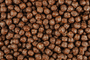 Background of brown cold cereals, top view, quick breakfast for kids