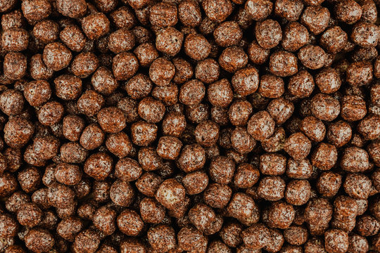 Background Of Brown Cold Cereals, Top View, Quick Breakfast For Kids