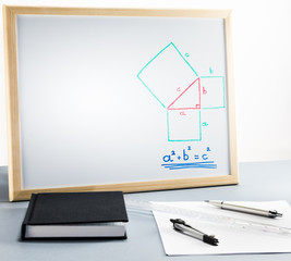 A whiteboard with the pythagorean theorem for teaching mathematics in school - 183233597