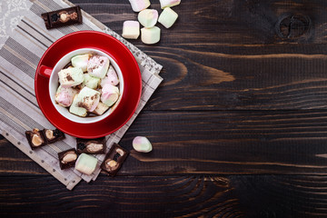 Cup of hot chocolate and marshmallow on wooden  background, top view. Christmas drink.