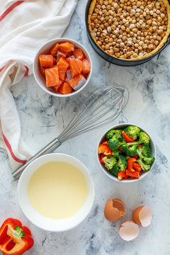 Ingredients to prepare pie with salmon and broccoli.