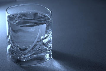 glass of water on a blue background
