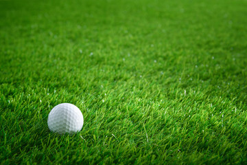 Golf ball on green grass in golf course