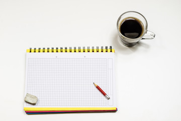 Coffee and sketchbook for drawings. White table. Isolated background.