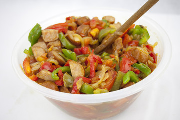 Delicious red souse from sausage, pepper and courgette in the ja