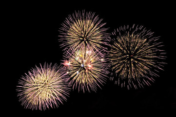 Flashes of festive salute fireworks of gold and lilac colors