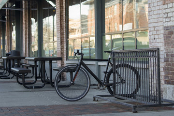 Bicycle on Bike Rack at an Urban Restaurant