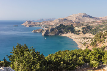 Obraz premium Stony landscape and a view of the Tsambika beach on the Rhodes Island, Greece