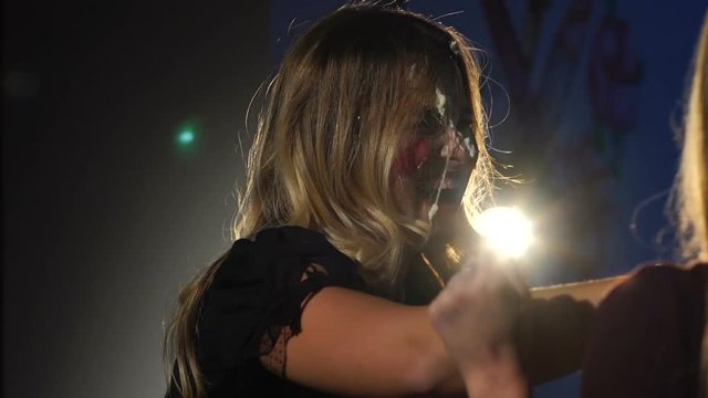 Girls smear each other's face with a cake