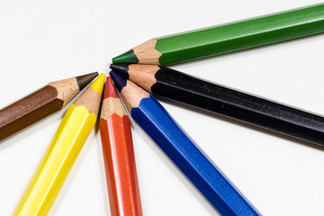 Naklejka premium Cute baby pencil crayons on a white table. Isolated background.