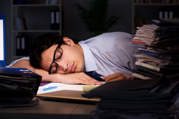 Young businessman working overtime late in office
