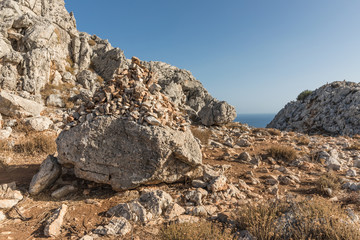Fototapeta na wymiar Stony landscape with trees of the Tsambika mountain on the Rhodes Island, Greece