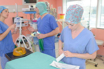 team of surgeons in the dark operating room