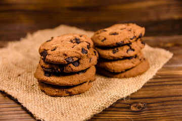 Chocolate chip cookies on sackcloth on a wooden table