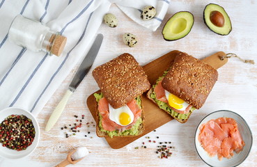 Smoked Salmon Sandwich with Avocado and Quail Egg Food Healthy Breakfast Wooden Background