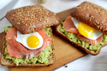 Smoked Salmon Sandwich with Avocado and Quail Egg Food Healthy Breakfast Wooden Background