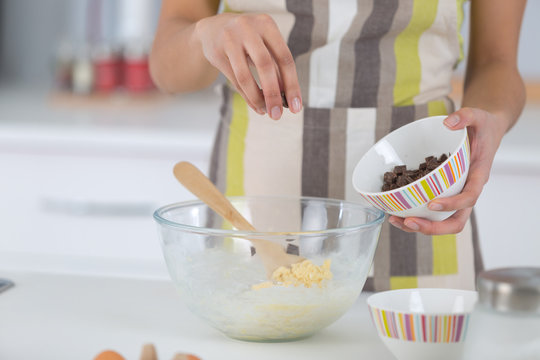Cook sprinking ingredient into bowl