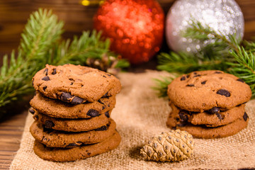 Chocolate chip cookies and christmas decorations on a wooden table