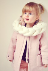 Beautiful Little Happy Blond Ginger Girl in Giant Knitted White Scarf