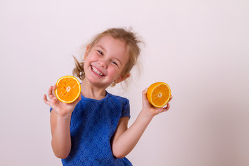 happy girl holding halves of orange