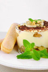 Tiramisu, traditional italian dssert on light background.