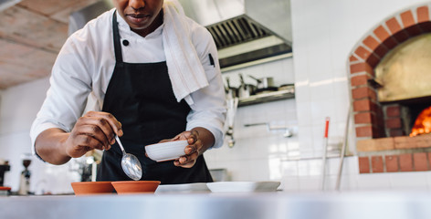 Chef doing food preparation at commercial kitchen