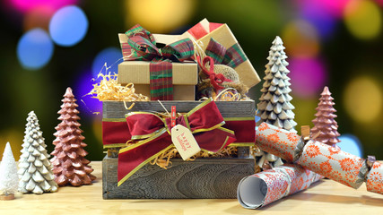 Large English style traditional Christmas hamper with paper wrapped gifts and food. static against bokeh lights of Christmas Tree. 
