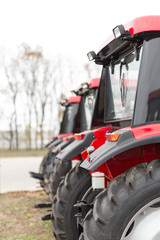 Equipment for agriculture, machines  presented to an agricultural exhibition.  Tractors outdoors