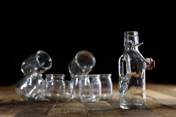 Glass empty containers on a wooden table. Jars, bottle.