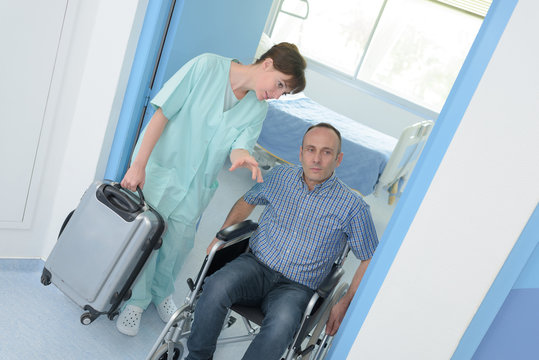 Man In Wheelchair Leaving Hospital