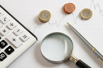 finance background with coins and magnifier glass