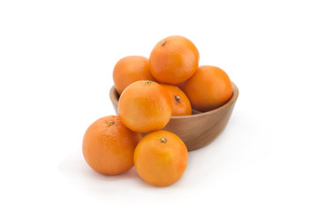 Orange tangerines on a wooden plate on a white background