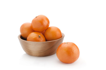Orange tangerines on a wooden plate on a white background