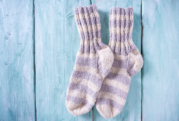knitted socks on turquoise wooden surface