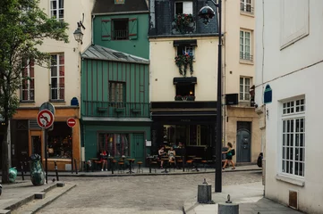 Fototapeten Typical view of the Parisian street with tables of cafe in Paris, France. © Ekaterina Belova